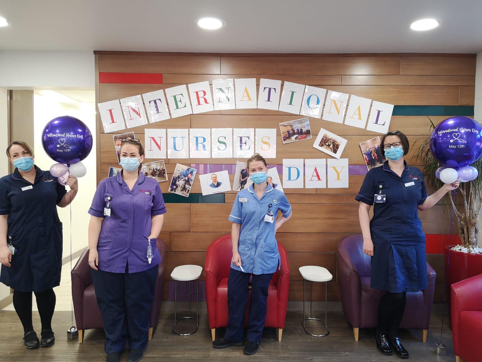 Colour photograph of nurses at Clatterbridge Private Clinic celebrating International Nurses Day 2021 with balloons and banner