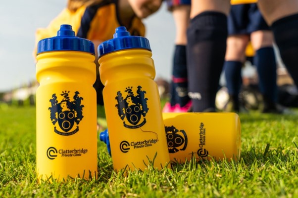 Photograph of the Oldershaw Diamonds water bottles with the Oldershaw FC badge and the Clatterbridge Private Clinic badge on the front. 