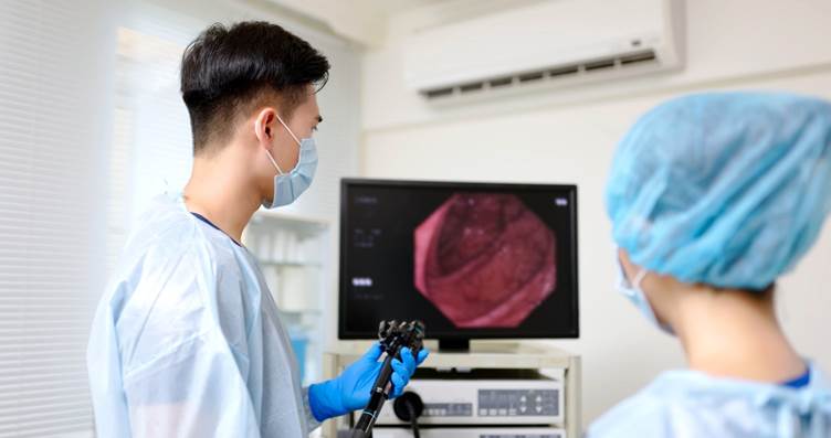 Two doctors conducting a colonoscopy 