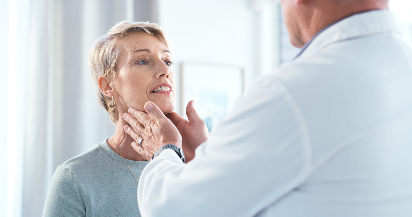 Male Senior Doctor Consulting a Female Senior Patient During Medical Examination